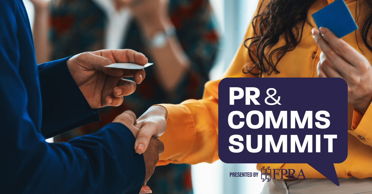 Business card exchange while shaking hands with PR & Comms Summit logo